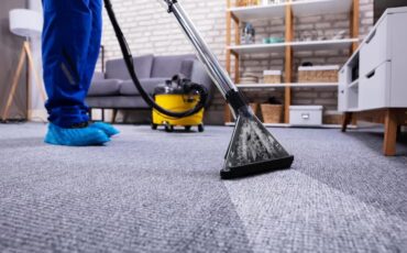 person-cleaning-carpet-with-vacuum-cleaner