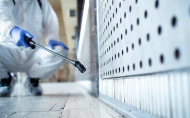 imgi_14_unrecognizable-person-white-chemical-protection-suit-doing-disinfection-public-areas-stop-spreading-highl