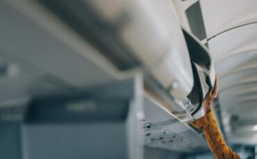 imgi_21_young-female-tourist-with-luggage-walking-through-airplane-cabin-ready-travel-adventure_265022-95810