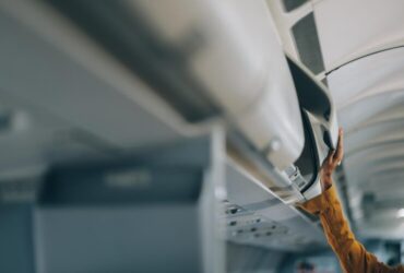 imgi_21_young-female-tourist-with-luggage-walking-through-airplane-cabin-ready-travel-adventure_265022-95810